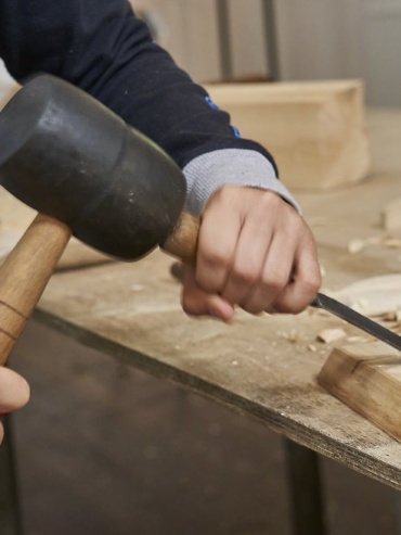 Zdjęcie przedstawia ręce z narzędziami